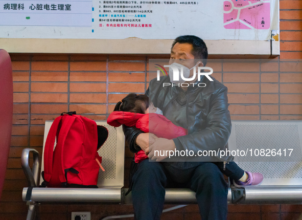 Parents and children with respiratory infectious diseases are waiting to see a doctor at the Children's Hospital in Chongqing, China, on Dec...