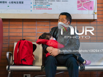 Parents and children with respiratory infectious diseases are waiting to see a doctor at the Children's Hospital in Chongqing, China, on Dec...