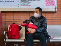 Parents and children with respiratory infectious diseases are waiting to see a doctor at the Children's Hospital in Chongqing, China, on Dec...