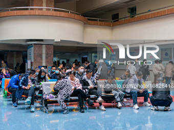 Parents and children with respiratory infectious diseases are waiting to see a doctor at the Children's Hospital in Chongqing, China, on Dec...