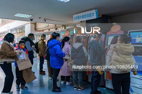 Parents and children with respiratory infectious diseases are waiting to see a doctor at the Children's Hospital in Chongqing, China, on Dec...