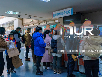 Parents and children with respiratory infectious diseases are waiting to see a doctor at the Children's Hospital in Chongqing, China, on Dec...