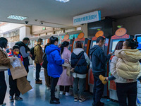 Parents and children with respiratory infectious diseases are waiting to see a doctor at the Children's Hospital in Chongqing, China, on Dec...