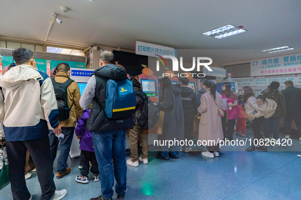 Parents and children with respiratory infectious diseases are waiting to see a doctor at the Children's Hospital in Chongqing, China, on Dec...