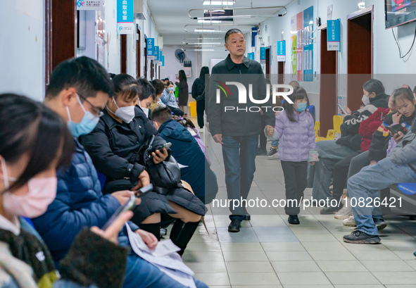 Parents and children with respiratory infectious diseases are waiting to see a doctor at the Children's Hospital in Chongqing, China, on Dec...