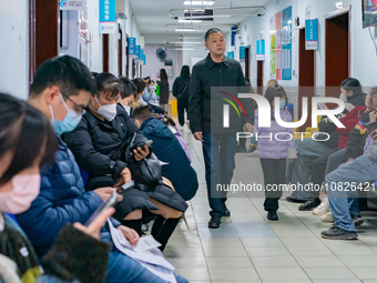 Parents and children with respiratory infectious diseases are waiting to see a doctor at the Children's Hospital in Chongqing, China, on Dec...