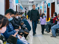 Parents and children with respiratory infectious diseases are waiting to see a doctor at the Children's Hospital in Chongqing, China, on Dec...