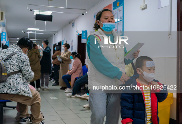 Parents and children with respiratory infectious diseases are waiting to see a doctor at the Children's Hospital in Chongqing, China, on Dec...