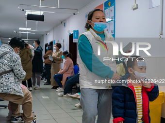 Parents and children with respiratory infectious diseases are waiting to see a doctor at the Children's Hospital in Chongqing, China, on Dec...