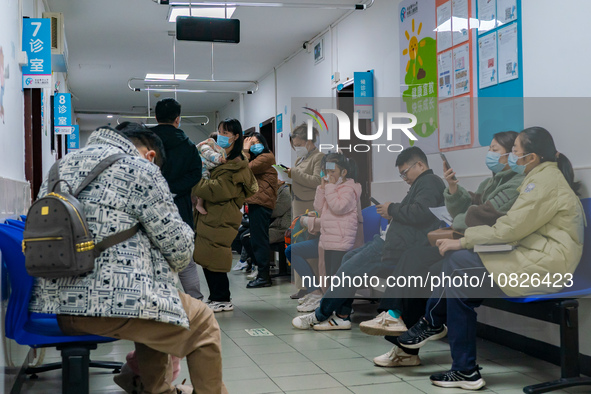 Parents and children with respiratory infectious diseases are waiting to see a doctor at the Children's Hospital in Chongqing, China, on Dec...