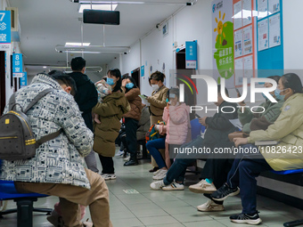 Parents and children with respiratory infectious diseases are waiting to see a doctor at the Children's Hospital in Chongqing, China, on Dec...