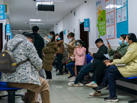 Parents and children with respiratory infectious diseases are waiting to see a doctor at the Children's Hospital in Chongqing, China, on Dec...