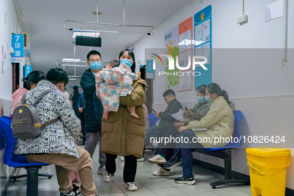 Parents and children with respiratory infectious diseases are waiting to see a doctor at the Children's Hospital in Chongqing, China, on Dec...