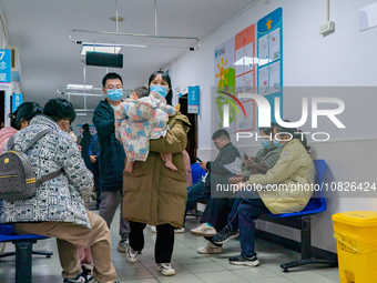 Parents and children with respiratory infectious diseases are waiting to see a doctor at the Children's Hospital in Chongqing, China, on Dec...