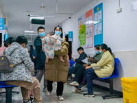 Parents and children with respiratory infectious diseases are waiting to see a doctor at the Children's Hospital in Chongqing, China, on Dec...