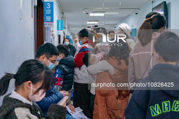 Parents and children with respiratory infectious diseases are waiting to see a doctor at the Children's Hospital in Chongqing, China, on Dec...