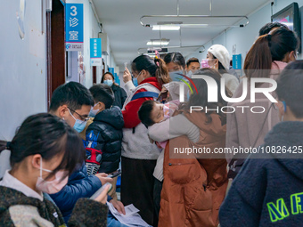 Parents and children with respiratory infectious diseases are waiting to see a doctor at the Children's Hospital in Chongqing, China, on Dec...