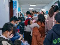 Parents and children with respiratory infectious diseases are waiting to see a doctor at the Children's Hospital in Chongqing, China, on Dec...