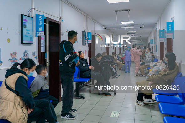 Parents and children with respiratory infectious diseases are waiting to see a doctor at the Children's Hospital in Chongqing, China, on Dec...