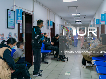 Parents and children with respiratory infectious diseases are waiting to see a doctor at the Children's Hospital in Chongqing, China, on Dec...