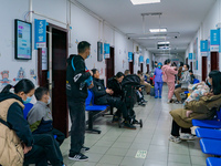 Parents and children with respiratory infectious diseases are waiting to see a doctor at the Children's Hospital in Chongqing, China, on Dec...