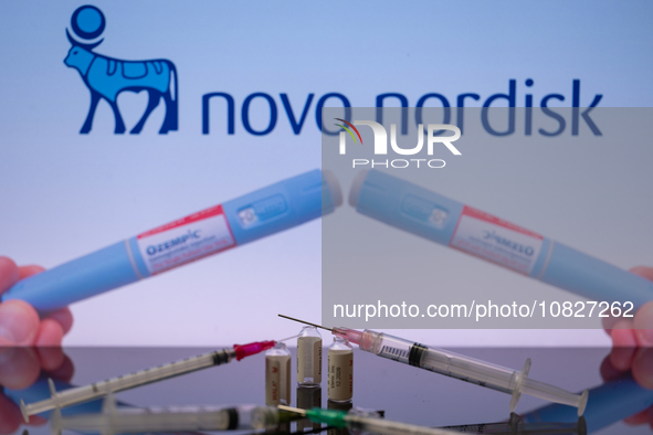 The Novo Nordisk pharmaceutical logo is being displayed on a screen alongside pills and a medical vial with a syringe in this photo illustra...