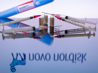 The Novo Nordisk pharmaceutical logo is being displayed on a screen alongside pills and a medical vial with a syringe in this photo illustra...