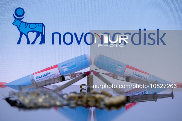 The Novo Nordisk pharmaceutical logo is being displayed on a screen alongside pills and a medical vial with a syringe in this photo illustra...