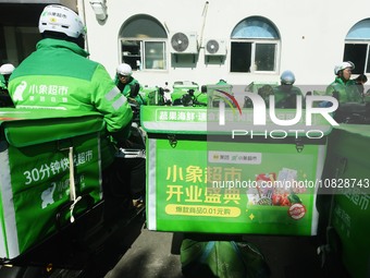 Employees of Meituan are waiting for delivery orders at the advance warehouse of Xiaoxiang supermarket in Hangzhou, Zhejiang Province, China...