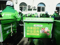 Employees of Meituan are waiting for delivery orders at the advance warehouse of Xiaoxiang supermarket in Hangzhou, Zhejiang Province, China...