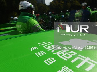 Employees of Meituan are waiting for delivery orders at the advance warehouse of Xiaoxiang supermarket in Hangzhou, Zhejiang Province, China...