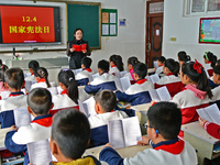 A teacher is leading students in reading the Constitution at Xiguan Primary School in the Fushan District of Yantai, Shandong Province, Chin...