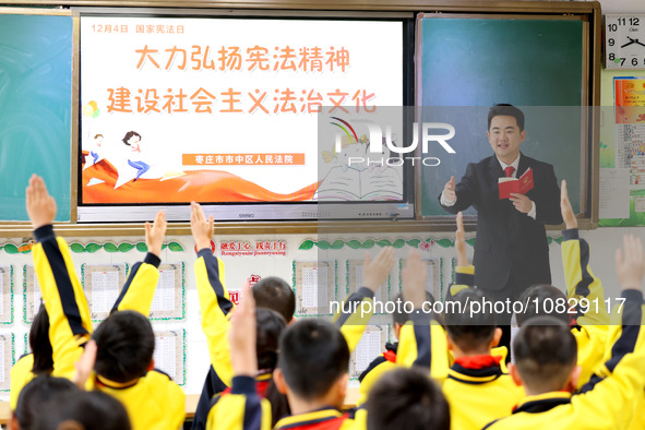 Judges are promoting constitutional knowledge to students at Wenhua Road Primary School in Zaozhuang, Shandong Province, China, on December...