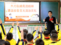 Judges are promoting constitutional knowledge to students at Wenhua Road Primary School in Zaozhuang, Shandong Province, China, on December...