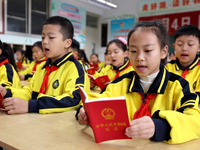 Primary school students are reading the Constitution in Zaozhuang, Shandong Province, China, on December 4, 2023. (