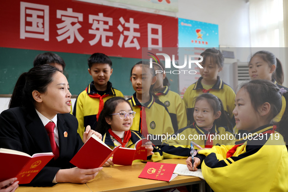 A judge is explaining the basic knowledge of the Constitution to students at Wenlu Primary School in Zaozhuang, Shandong Province, China, on...