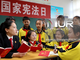 A judge is explaining the basic knowledge of the Constitution to students at Wenlu Primary School in Zaozhuang, Shandong Province, China, on...