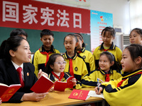 A judge is explaining the basic knowledge of the Constitution to students at Wenlu Primary School in Zaozhuang, Shandong Province, China, on...