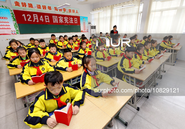 A judge is reading the Constitution with students at Wenlu Primary School in Zaozhuang, Shandong Province, China, on December 4, 2023. 