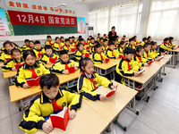 A judge is reading the Constitution with students at Wenlu Primary School in Zaozhuang, Shandong Province, China, on December 4, 2023. (