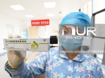 A medical worker at a community health service center is showing a flu vaccine in Guiyang, Guizhou Province, China, on December 7, 2023. (