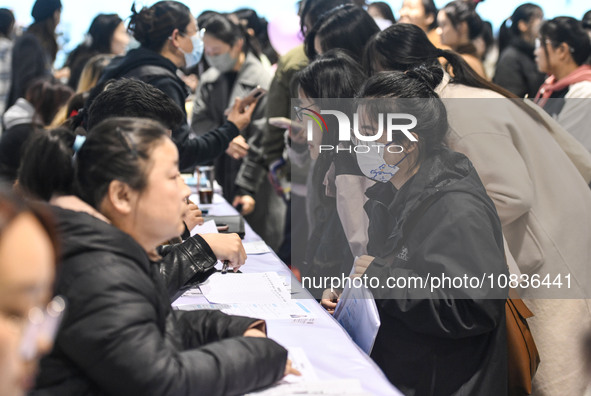 College student job seekers are communicating with representatives of employers at a college employment fair in Fuyang, Anhui Province, Chin...