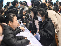 College student job seekers are communicating with representatives of employers at a college employment fair in Fuyang, Anhui Province, Chin...