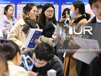 College student job seekers are communicating with representatives of employers at a college employment fair in Fuyang, Anhui Province, Chin...