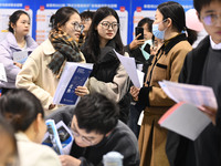 College student job seekers are communicating with representatives of employers at a college employment fair in Fuyang, Anhui Province, Chin...