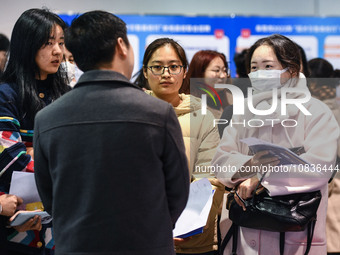 College student job seekers are communicating with representatives of employers at a college employment fair in Fuyang, Anhui Province, Chin...