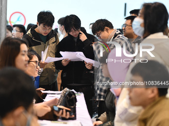 College student job seekers are communicating with representatives of employers at a college employment fair in Fuyang, Anhui Province, Chin...