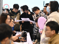 College student job seekers are communicating with representatives of employers at a college employment fair in Fuyang, Anhui Province, Chin...