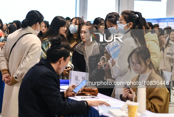 College student job seekers are communicating with representatives of employers at a college employment fair in Fuyang, Anhui Province, Chin...