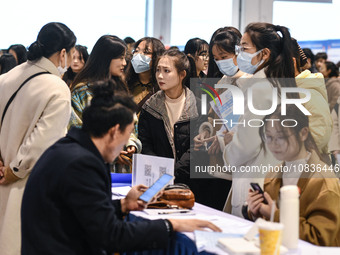 College student job seekers are communicating with representatives of employers at a college employment fair in Fuyang, Anhui Province, Chin...